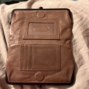 Tan Hobo bi fold wallet. Closes with metal clasps and magnets